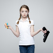 Studio shot of girl (10-11) holding handgun and crayons