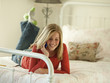 Photo: "USA, Utah, Cedar Hills, Teenage girl (14-15) lying on bed, talking on mobile phone" "USA, Utah, Cedar Hills, Teenage girl (14-15) lying on bed, talking on mobile phone"