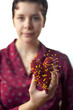 "USA, Utah, Provo, Young woman holding heart-shaped cushion with yellow pins"