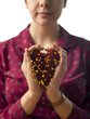 "USA, Utah, Provo, Young woman holding heart-shaped cushion with yellow pins"