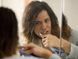 "USA, Utah, Provo, Young woman brushing teeth"
