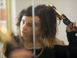 "USA, Utah, Provo, Young woman using curler in front of mirror"