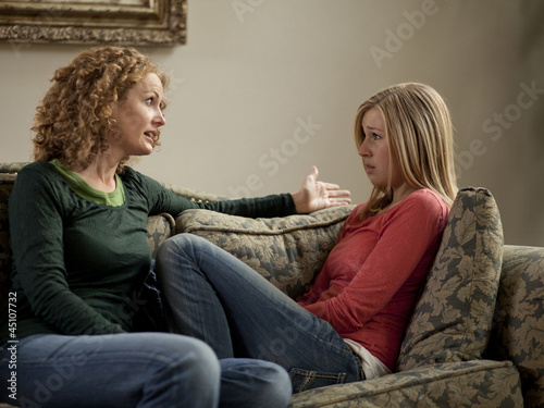 Photo: "USA, Utah, Cedar Hills, Mother with teenage girl (14-15) arguing on sofa" "USA, Utah, Cedar Hills, Mother with teenage girl (14-15) arguing on sofa"