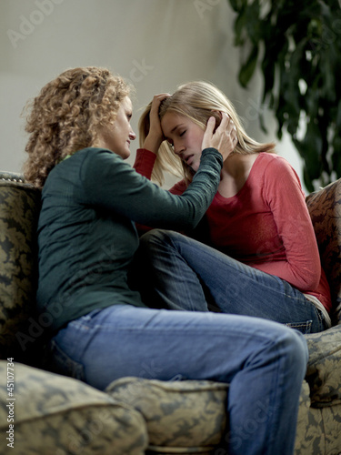 Photo: "USA, Utah, Cedar Hills, Mother consoling teenage girl (14-15)" "USA, Utah, Cedar Hills, Mother consoling teenage girl (14-15)"