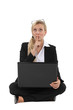 Businesswoman thinking at her laptop
