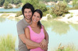 Couple stood by lake
