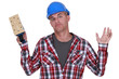 Construction worker holding up a sander