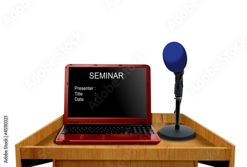 Photo: microphone and laptop on podium at seminar microphone and laptop on podium at seminar