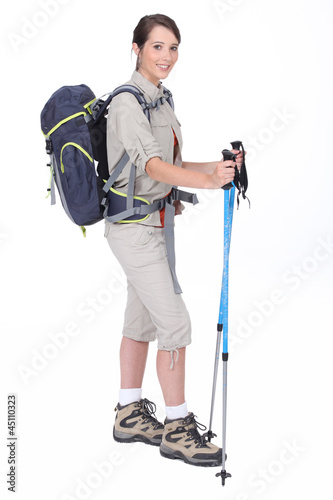 Photo: A young woman with hiking gears. A young woman with hiking gears.