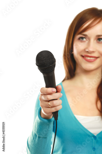 Photo: Smiling woman with microphone isolated on white background Smiling woman with microphone isolated on white background