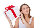 Foto: Mädchen schüttelt sanft ein Geschenk Mädchen schüttelt sanft ein Geschenk