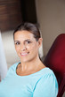 Happy Woman Sitting In Chair