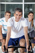 Photo: Three People On Exercise Bikes Three People On Exercise Bikes