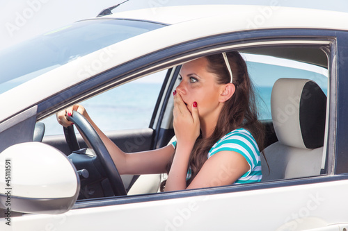 Photo: A scared woman is in the car A scared woman is in the car