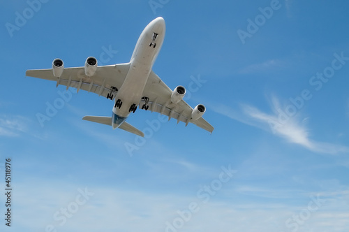 Photo: jet aircraft on take-off or landing in blue sky jet aircraft on take-off or landing in blue sky