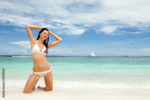 Photo: Happy young woman rest on the beach Happy young woman rest on the beach