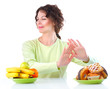 Diet. Beautiful Young Woman choosing between Fruits and Sweets