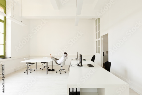 Photo: interior, office with modern furniture, man relaxes interior, office with modern furniture, man relaxes