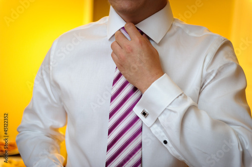 Photo: Groom fixing tie Groom fixing tie