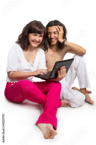 Photo: Happy young couple with the computer Happy young couple with the computer