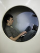man inside a commercial clothes dryer at a laundromat