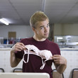 man holding up a bra