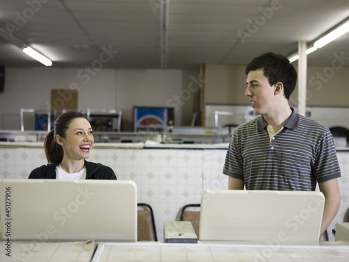 Photo: man and woman at a laundromat man and woman at a laundromat
