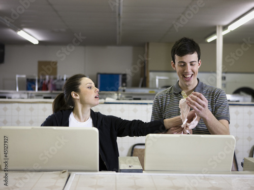 Photo: man and woman at a laundromat man and woman at a laundromat