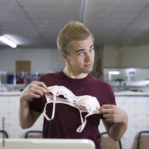 Photo: man holding up a bra man holding up a bra