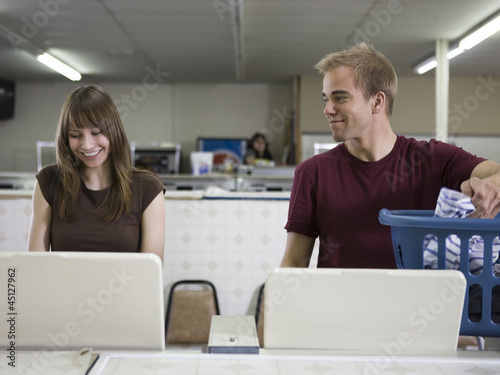 Photo: man and woman at a laundromat man and woman at a laundromat