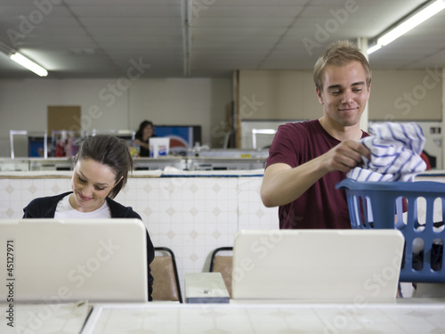 Photo: man and woman at a laundromat man and woman at a laundromat