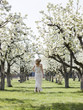 woman in a blossoming orchard