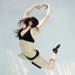 woman swimming underwater in a pool