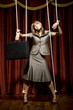 businesswoman being pulled by strings like a puppet