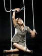 businesswoman being pulled by strings like a puppet