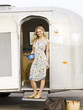 woman standing outside her airstream classic trailer