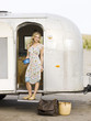 woman standing outside her airstream classic trailer