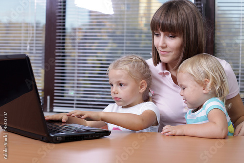 Photo: Mother with two young daughters Mother with two young daughters