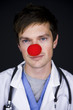 doctor wearing a red clown nose