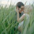 Photo: "USA, Utah, Salt Lake City, Young happy couple embracing, blades of grass in foreground" "USA, Utah, Salt Lake City, Young happy couple embracing, blades of grass in foreground"