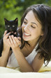 "USA, Utah, Orem, Portrait of woman holding kitten"