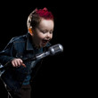 little boy singing into a microphone