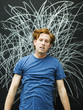 Photo : Studio portrait of man with chalk scribble on blackboard Studio portrait of man with chalk scribble on blackboard