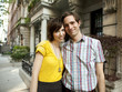 Photo: "USA, New York, New York City, Portrait of young couple in front of apartment building" "USA, New York, New York City, Portrait of young couple in front of apartment building"