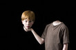boy holding his decapitated head in his hand