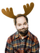 man in a plaid shirt wearing antlers