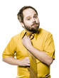 man in a yellow shirt and tie fixing his tie