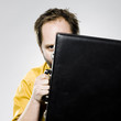 man hiding behind his briefcase