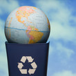 globe in a recycling bin