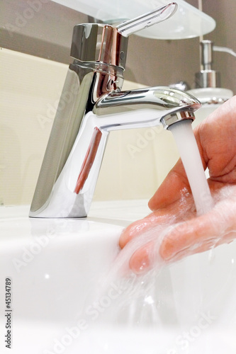 Photo: Washing arm in sink bathroom. Washing arm in sink bathroom.